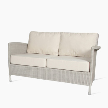 Vincent Sheppard Safi two-seater lounge sofa in old lace with a woven rattan design, featuring cushioned seat and backrest for added comfort.